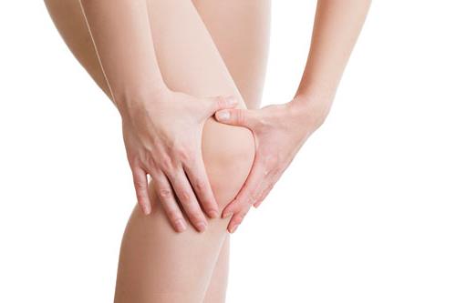 Knee pain of the woman. Isolated on white background.