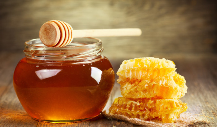 jar of honey with honeycomb