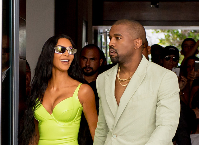 Kim Kardashian shined extra bright in neon and she and Kanye West arrive at Miamis Versace Mansion for rapper 2Chainz Wedding on Saturday