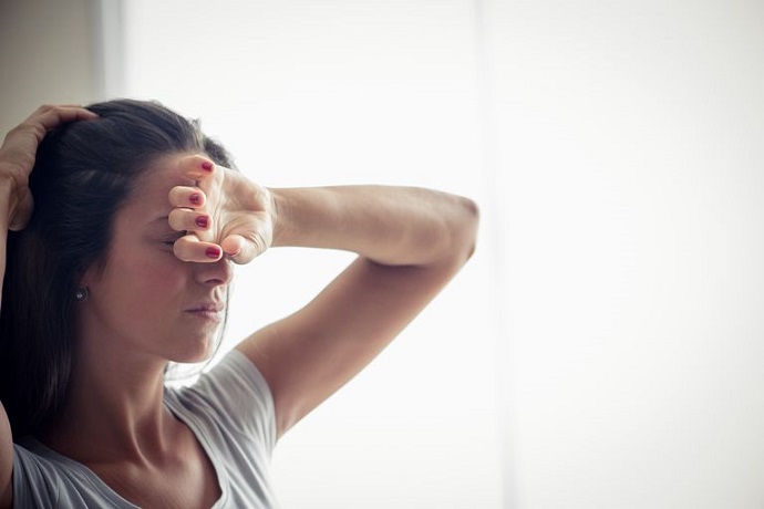 young-woman-holding-one-hand-on-forehead-royalty-free-image-881204518-15336749591