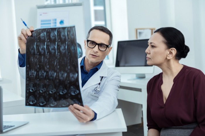 Experienced doctor showing a brain scan