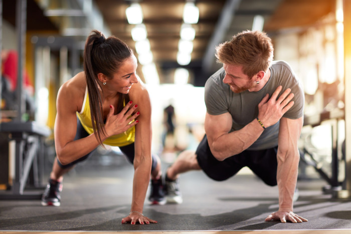 Man and woman strengthen hands at fitness training