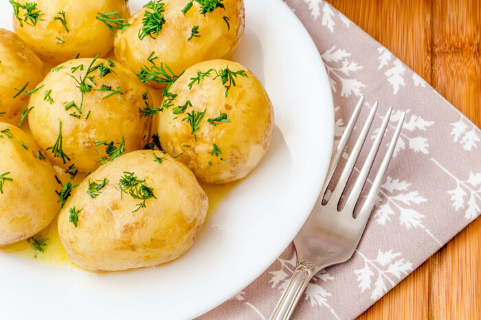 Traditional Ukrainian food boiled new potatoes with butter and dill