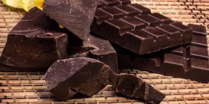 Dark chocolate with a flower on a mat